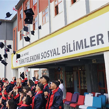 students throwing caps to air front of a school