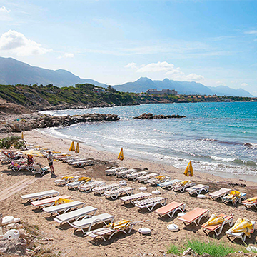 beautiful beach with sun beds and umbrellas
